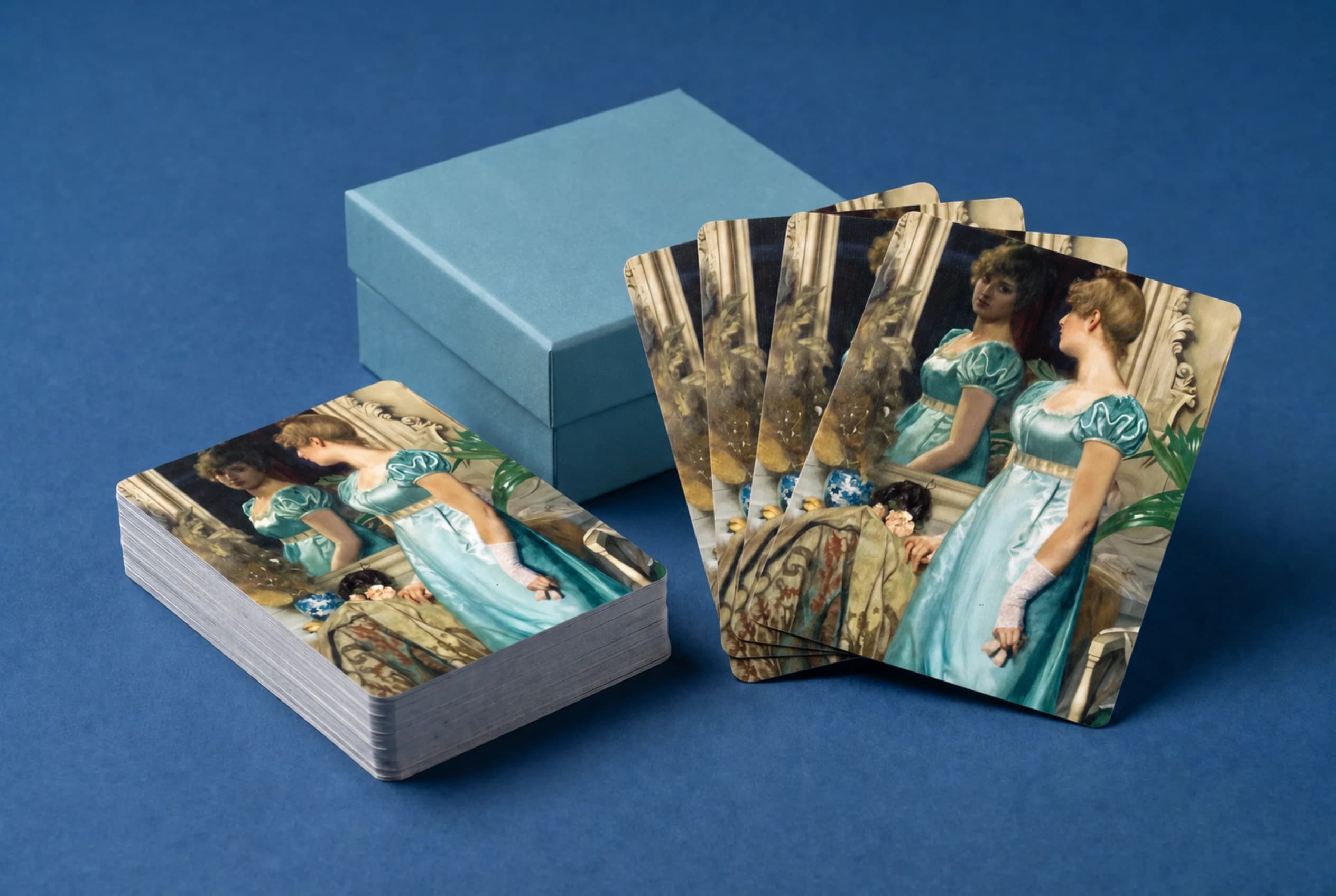 Standard Edition cards with mirror-lady artwork backs beside a plain powder-blue cardboard keepsake box